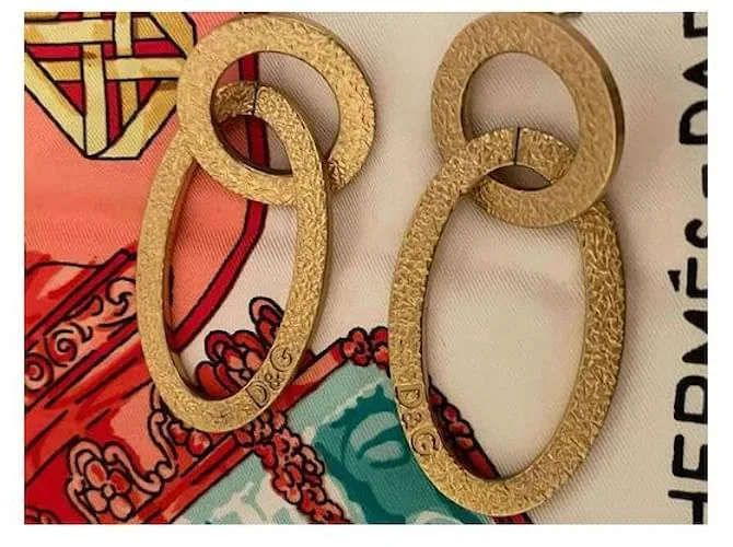Pendientes dorados DOLCE & GABBANA con círculo alargado y logo 
