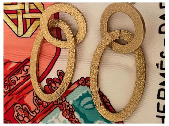 Pendientes dorados DOLCE & GABBANA con círculo alargado y logo 